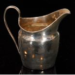 A George III hallmarked silver cream jug of helmet form with reeded handle and bright cut