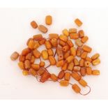 A single string of barrel shaped opaque amber beads of caramel to butterscotch colour sizes 13mm to