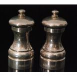 A pair of modern salt and pepper mills each of plain waisted from engraved S and P to button