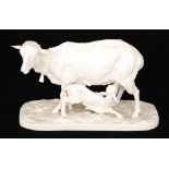 A late 19th Century blanc de chine model as a goat stood on a naturalistic base with a kid goat