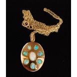 A modern opal pendant designed as an oval yellow metal panel inset with eight cabochon opals,