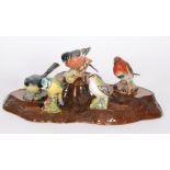 Five assorted Beswick birds comprising a 992 Blue Tit, 2413 Goldcrest, 1041 Grey Wagtail,