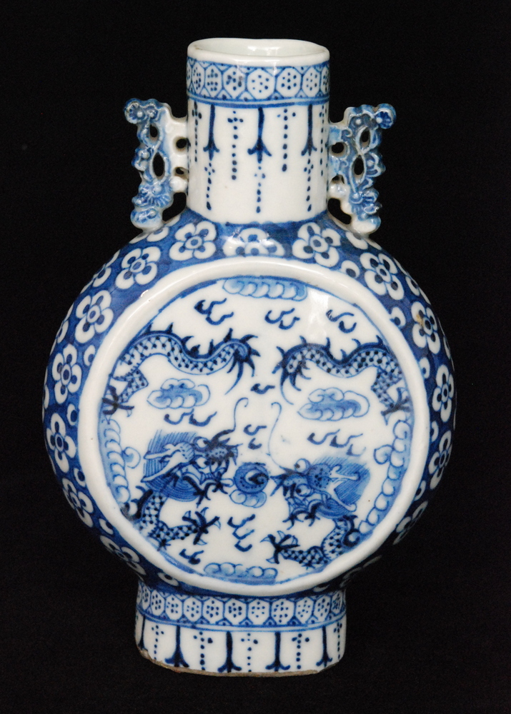 A 19th Century Chinese blue and white moon flask decorated with stylised dragons amidst clouds