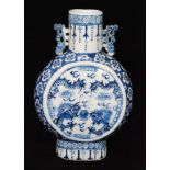 A 19th Century Chinese blue and white moon flask decorated with stylised dragons amidst clouds