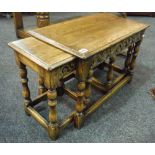 A 17th Century style carved oak occasional table with scroll decorated frieze on turned baluster