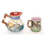 Two pieces of late 19th Century majolica comprising a jug decorated with relief moulded fish