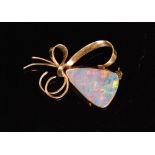 A 9ct mounted opal brooch, the triangular opal collar set with wirework bow shaped sprays,