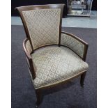 An Edwardian armchair with exposed mahogany crossbanded frame with scroll capitals to the top rail.