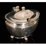 A George III hallmarked silver oval mustard with hinged lid, gadrooned border and scroll handle,