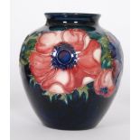 A Moorcroft vase of ovoid form with a roll rim neck decorated in the Anemone pattern with tubelined