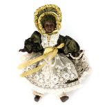 A small German black bisque head doll with fixed brown eyes and open mouth,