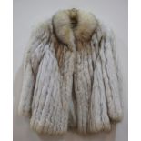 A lady's vintage half length blue arctic fox fur coat, labelled Saga Fox to the blue rayon lining,