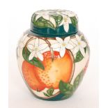 A small Moorcroft Pottery ginger jar and cover decorated in the Orange and Blossoms pattern,