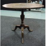 A 19th Century country oak snap top supper table of circular form,
