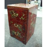 A late 20th Century red lacquered chest of three drawers in the Chinese taste,