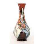 A Moorcroft Pottery bottle vase decorated in the Red Tulip pattern designed by Sally Tuffin,