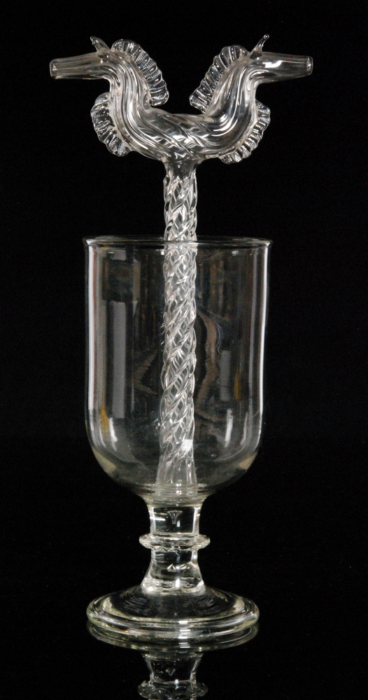 A late 19th to early 20th Century clear crystal glass marriage goblet of footed form with a central