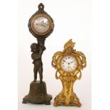 An early 20th Century Art Nouveau gilt cased mantle clock together with a spelter clock in the form