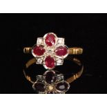 An 18ct hallmarked ruby and diamond cluster ring,