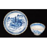 A 19th Century Chinese blue and white scallop edge tea bowl and saucer decorated with two figures