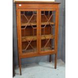 An Edwardian line inlaid and satinwood banded display cabinet enclosed by a pair of astragal glazed
