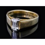 A modern 18ct hallmarked diamond solitaire ring, claw set baguette cut stone,