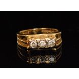 An 18ct hallmarked diamond three stone ring,