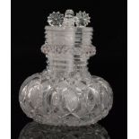 A 19th Century clear cut crystal glass four compartment scent bottle of compressed ovoid form with