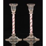 A pair of early 20th Century clear crystal glass candlesticks in the 18th Century taste,