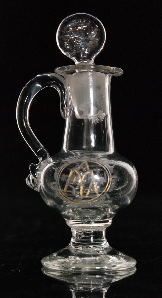 An 18th Century travelling communion wine jug with conical foot,
