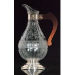 An early 20th Century Stourbridge clear crystal water jug of ovoid form with collar neck and