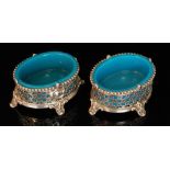 A pair of late 19th Century French glass table salts of oval section in opaque turquoise blue to