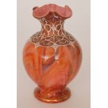 A late 19th Century Loetz Carneol vase of footed ovoid form with collar neck and quatrelobed rim,