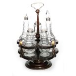 A late 18th Century cruet set comprising five matched clear crystal glass bottles all with flat cut