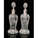A pair of early 20th Century Stevens & Williams clear crystal glass decanters by Frederick Carder