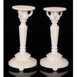 A pair of large late 19th Century blanc-de-lait pressed glass candlesticks attributed to Sowerby
