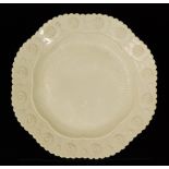 A late 19th Century Sowerby Queens Ivory pressed glass plate of octagonal form with moulded daisies