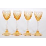 A set of four 1930s Stuart & Sons Art Deco wine glasses with a golden amber bowl cut and polished