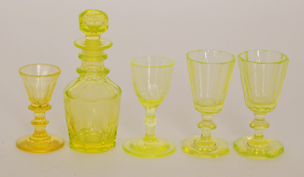A 19th Century miniature uranium glass decanter of shouldered form with basal and shoulder slice
