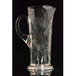 A clear crystal glass jug of fluted sleeve form with integral spout and applied loop handle,