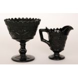 A late 19th Century Davidson black pressed glass pedestal sugar bowl relief moulded with trailing