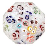 A 19th Century French paperweight by Baccarat decorated with a spaced millefiori ground with