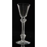 An 18th Century drinking glass circa 1755 round funnel bowl above a multiple series air twist stem
