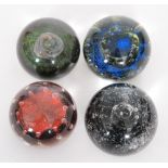 A set of four later 20th Century Caithness limited edition paperweights designed by Colin Terris