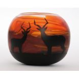 A contemporary studio glass vase by Vicky Beech of squat ovoid form cased in black over the orange,