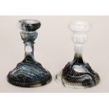 A pair of 19th Century black and white marbled glass candlesticks,