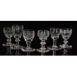 A small collection of late 18th Century tot glasses with ogee bowls decorated with various cut and