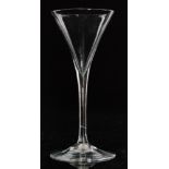 An 18th Century toasting glass circa 1780 with drawn trumpet bowl above a slender plain stem with