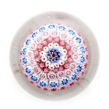 A late 19th Century Old English paperweight with a concentric millefiori cane work canopy in red,