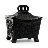 A late 19th Century Sowerby black pressed glass miniature tea caddy in the Aesthetic taste of